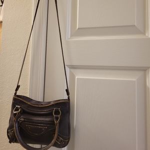 Distressed small purple shoulder bag.